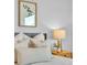 Bedroom with plush pillows, modern decor, and a bedside table with elegant lamp at 1529 Rio Vista Ter, Parrish, FL 34219