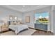 Comfortable bedroom featuring a bed with soft pillows, bedside tables, and a scenic window view at 1529 Rio Vista Ter, Parrish, FL 34219