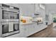 A modern oven in a bright kitchen that offers stone countertops, white cabinets, and a wood-grain floor at 1529 Rio Vista Ter, Parrish, FL 34219