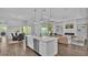 A modern kitchen with a large center island, stainless steel appliances, and an open layout connecting to the living room at 1529 Rio Vista Ter, Parrish, FL 34219