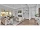 Bright living room featuring a modern fireplace, sleek shelving, comfortable seating, and natural light pouring in from the pool view at 1529 Rio Vista Ter, Parrish, FL 34219