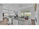 Open-concept living room boasts abundant natural light, comfortable seating, seamless transition to the kitchen and pool area at 1529 Rio Vista Ter, Parrish, FL 34219