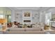 A bright living room with a modern fireplace, decorative shelving, and comfortable seating arranged for relaxation and conversation at 1529 Rio Vista Ter, Parrish, FL 34219