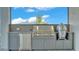 Modern outdoor kitchen featuring stainless steel appliances, providing a stylish cooking experience with backyard views at 1529 Rio Vista Ter, Parrish, FL 34219