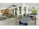 Spacious outdoor lounge area with ceiling fans, comfortable seating, and an outdoor kitchen, perfect for entertaining at 1529 Rio Vista Ter, Parrish, FL 34219