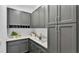Well-organized pantry with gray cabinets, white countertops, and ample storage space at 1529 Rio Vista Ter, Parrish, FL 34219