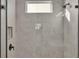 Modern shower with glass enclosure, stone tile, and sleek fixtures at 1529 Rio Vista Ter, Parrish, FL 34219