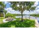 Picturesque waterfront park with picnic tables, benches, lush greenery, and dock access for enjoying the serene water views at 1529 Rio Vista Ter, Parrish, FL 34219