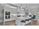 Modern kitchen with white cabinetry, stainless steel appliances, and an island at 1529 Rio Vista Ter, Parrish, FL 34219