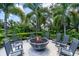 Relaxing fire pit area with seating and lush landscaping at 1529 Rio Vista Ter, Parrish, FL 34219
