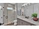 Modern bathroom with gray tile, glass shower, and updated vanity at 1529 Rio Vista Ter, Parrish, FL 34219