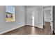 Bright bedroom with hardwood floors, double doors, and a window at 1529 Rio Vista Ter, Parrish, FL 34219