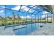Enclosed pool and spa with a covered patio and water view at 1529 Rio Vista Ter, Parrish, FL 34219