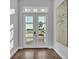 Bright and airy entryway with glass doors and hardwood floors at 1529 Rio Vista Ter, Parrish, FL 34219