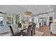 Open dining room with glass table, view of kitchen and patio at 1529 Rio Vista Ter, Parrish, FL 34219