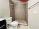 Clean bathroom with tile shower, toilet, and updated fixtures at 1860 Massachusetts Ne Ave # 214, St Petersburg, FL 33703