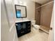 Updated bathroom with dark vanity, tile shower, and modern toilet at 1860 Massachusetts Ne Ave # 214, St Petersburg, FL 33703