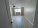 Spacious bedroom with light gray walls and wood-look tile floors at 1860 Massachusetts Ne Ave # 214, St Petersburg, FL 33703