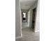 Hallway with tile flooring, large mirror, and built-in storage at 1860 Massachusetts Ne Ave # 214, St Petersburg, FL 33703