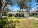 House exterior with a green lawn and mature trees at 3211 Pine Club Dr, Plant City, FL 33566