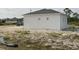 Rear view of the house showcasing its simple design at 13 Polar Ct, Placida, FL 33946