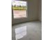Spacious bedroom featuring large window and marble tile floor at 63 Coxswaine Cir, Placida, FL 33946