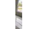 Bright bedroom with large window and marble-look tile floor at 63 Coxswaine Cir, Placida, FL 33946