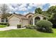 House exterior showcasing a two-car garage and well-maintained landscaping at 533 Bent Oak Ct, Spring Hill, FL 34609