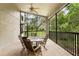 Relaxing screened porch with table and chairs, overlooking lush greenery at 533 Bent Oak Ct, Spring Hill, FL 34609
