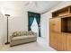 Bedroom with sofa, built-in shelving, and window at 533 Bent Oak Ct, Spring Hill, FL 34609