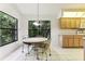 Cozy kitchen nook with a round table and chairs, offering a view of the backyard at 533 Bent Oak Ct, Spring Hill, FL 34609