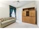 Bedroom with sofa, built-in shelving, and window at 533 Bent Oak Ct, Spring Hill, FL 34609