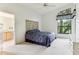 Main bedroom with a large window, ceiling fan and en-suite bathroom at 533 Bent Oak Ct, Spring Hill, FL 34609