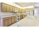 Well-equipped kitchen with light wood cabinets and modern appliances at 533 Bent Oak Ct, Spring Hill, FL 34609