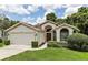 One-story home featuring a two-car garage and neatly landscaped yard at 533 Bent Oak Ct, Spring Hill, FL 34609