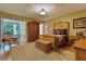 Spacious bedroom with hardwood floors, antique furniture, and an adjoining sitting area at 2340 Grecian Way # 46, Clearwater, FL 33763