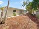 Large backyard with mature trees and a partially fenced area at 1900 63Rd S Ave, St Petersburg, FL 33712