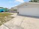 House exterior with a white garage door and landscaping at 1900 63Rd S Ave, St Petersburg, FL 33712