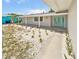 Front view of the house, showcasing the teal door and walkway at 1900 63Rd S Ave, St Petersburg, FL 33712