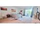 Bright bedroom with a queen-size bed and access to a balcony at 531 Spring Lakes Blvd # 531, Bradenton, FL 34210