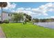 Landscaped lawn by a lake with a bench at 811 N Keene Rd # V7, Clearwater, FL 33755