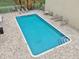 Community pool with lounge chairs at 811 N Keene Rd # V7, Clearwater, FL 33755