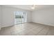 Bedroom with tile floor and access to balcony at 811 N Keene Rd # V7, Clearwater, FL 33755