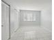 Well-lit bedroom with tile floors and mirrored closet doors at 811 N Keene Rd # V7, Clearwater, FL 33755