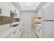 Updated kitchen with white cabinets, quartz countertops and new appliances at 811 N Keene Rd # V7, Clearwater, FL 33755