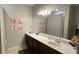Well-appointed bathroom with dark wood vanity, updated fixtures and a large mirror at 7224 Ketch Pl, Bradenton, FL 34212
