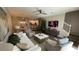 Open living room with hardwood floors, neutral decor, and view into kitchen at 7224 Ketch Pl, Bradenton, FL 34212