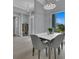 Bright dining room features a white table with grey chairs, and hardwood floors at 193 White Marsh Ln, Rotonda West, FL 33947