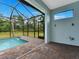 Covered patio with access to the pool and a view of the surrounding nature at 193 White Marsh Ln, Rotonda West, FL 33947
