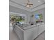Spacious living area with sliding glass doors leading to pool and lanai at 11 Tee View Rd, Rotonda West, FL 33947